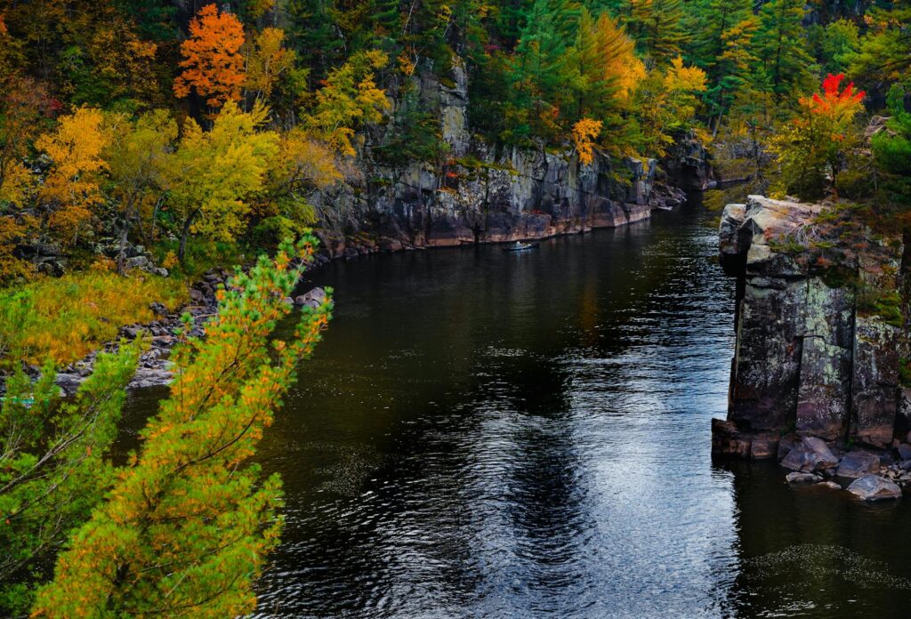 Beautiful autumn landscape featuring the St Croix River surrounded by colorful foliage in Taylors Falls, Minnesota.