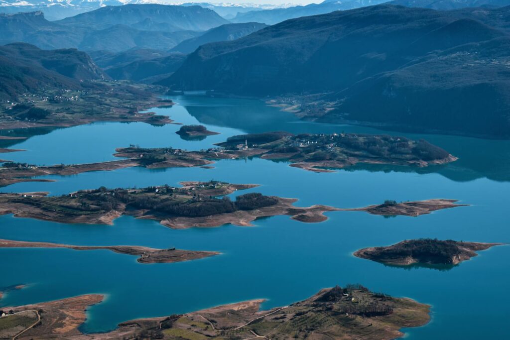 Stunning aerial view of a vibrant blue lake surrounded by mountains in Bosnia and Herzegovina.