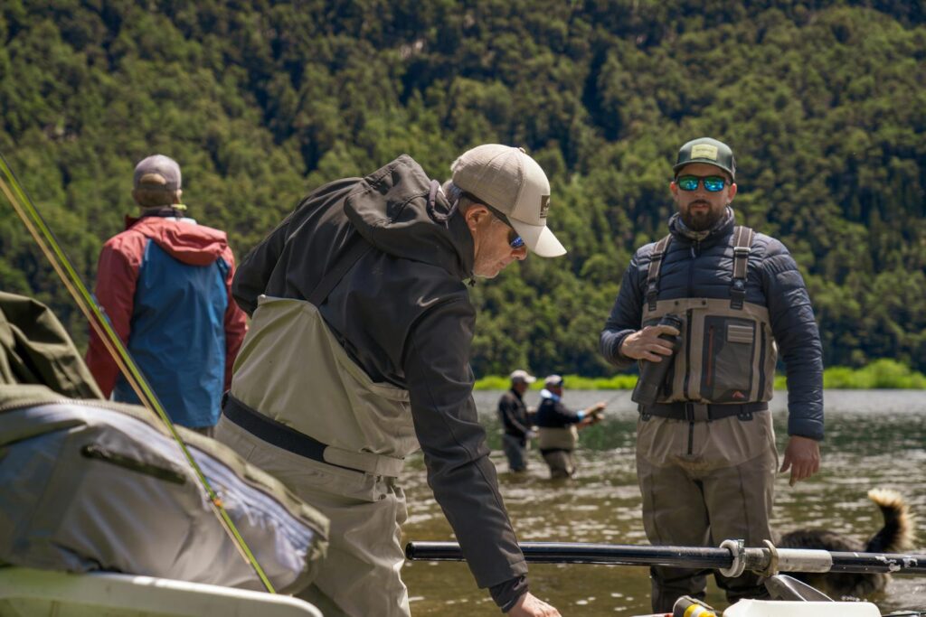 A group of men indulge in fly fishing at a scenic river in Patagonia, Argentina.