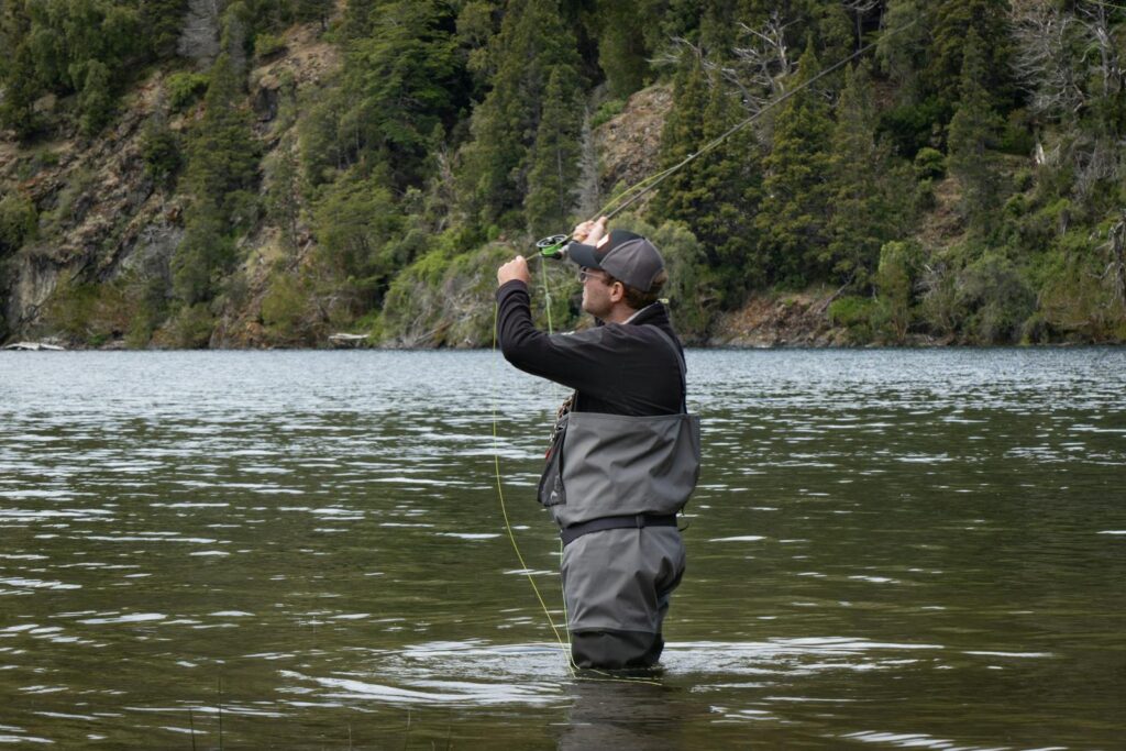 A man fly fishing in the serene rivers of Patagonia, ideal for adventure seekers.