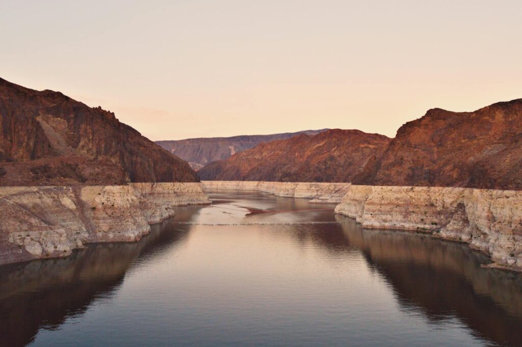 A stunning view of Lake Mead at sunset, showcasing the rocky desert landscape in Boulder City, Nevada.