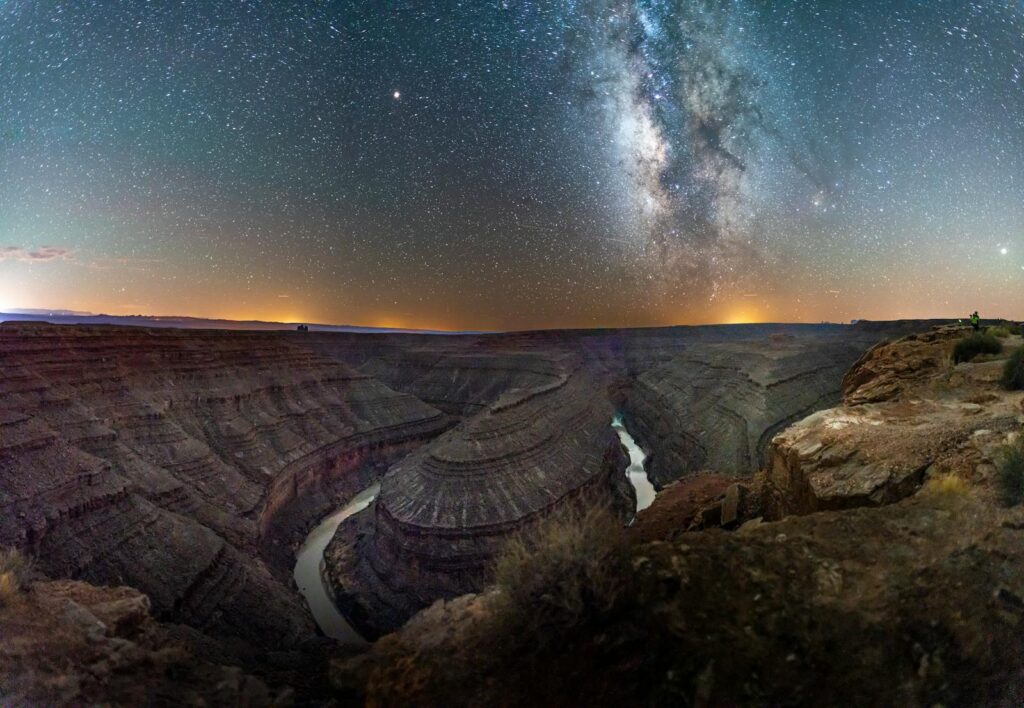 Vast starry sky above the winding San Juan River at Goosenecks State Park, Utah.