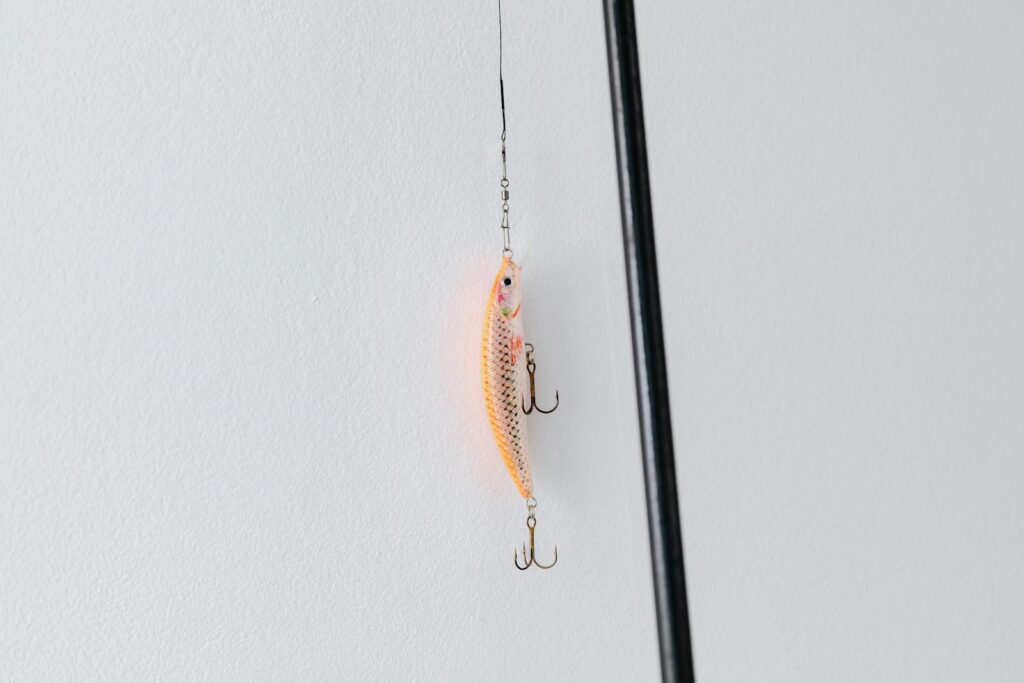 Detailed close-up of a fishing lure attached to a fishing rod, perfect for angling or fishing enthusiasts.