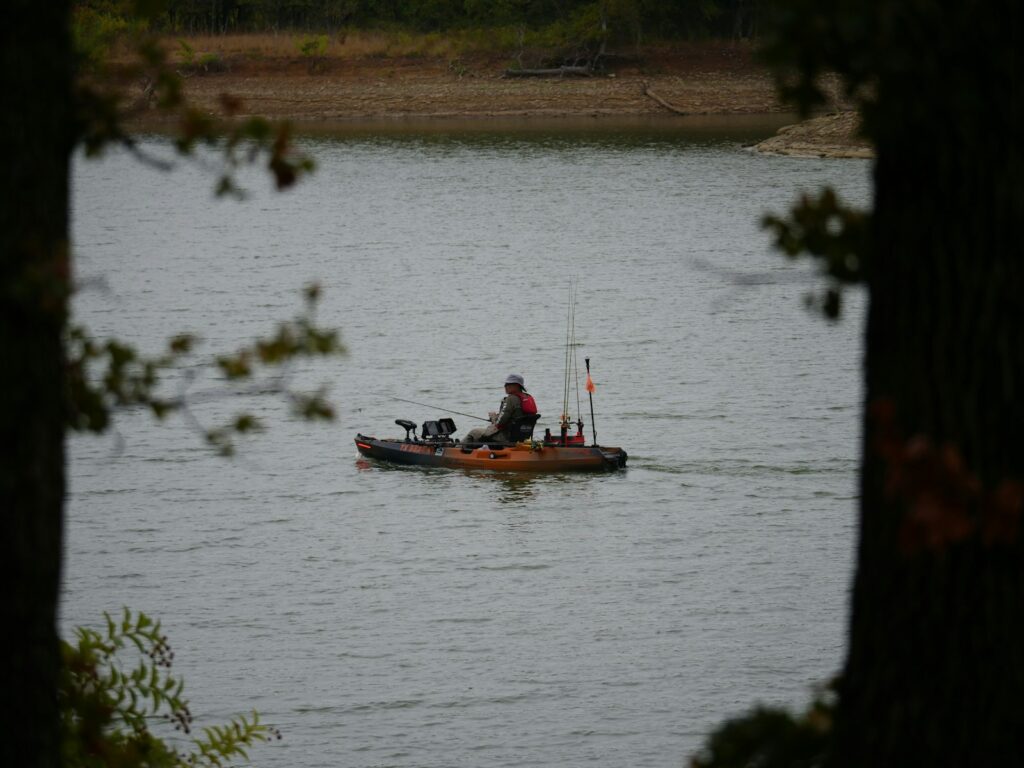 A man in a small boat on a lake