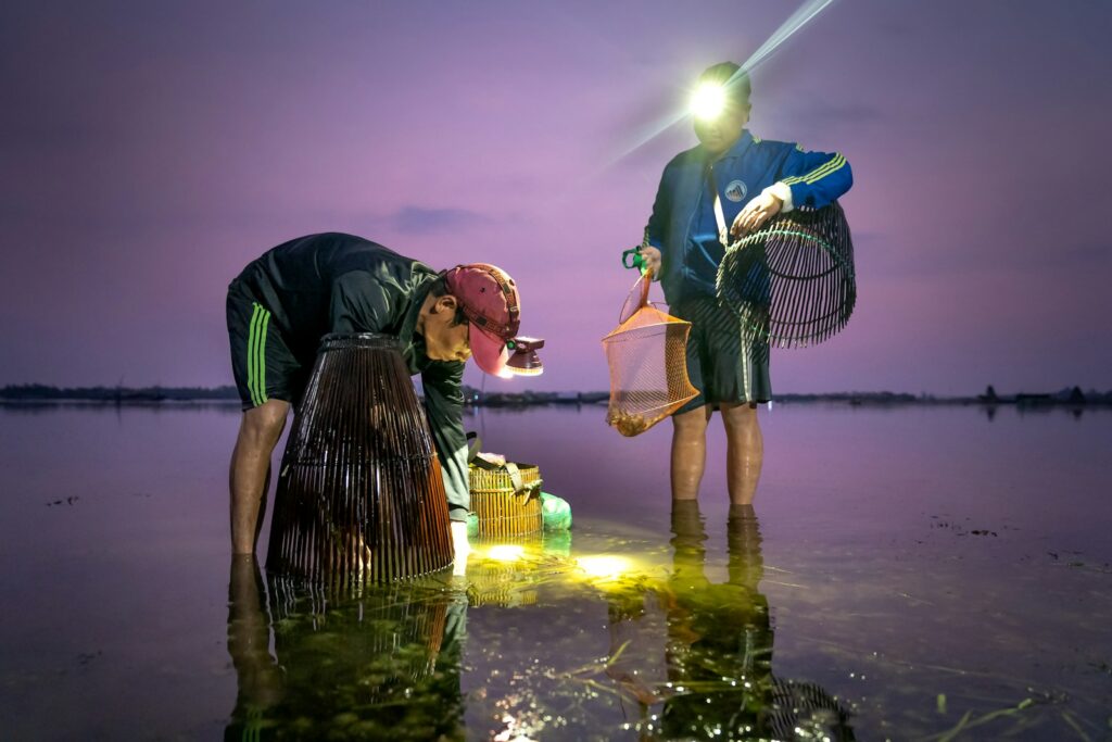 a couple of people that are standing in the water