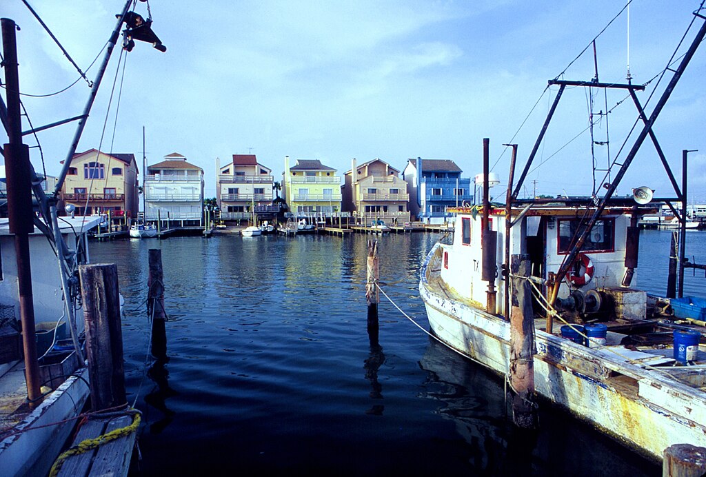 Small-scale fishermen and yachtsmen co-existing peacefully. Texas, Port Aransas.