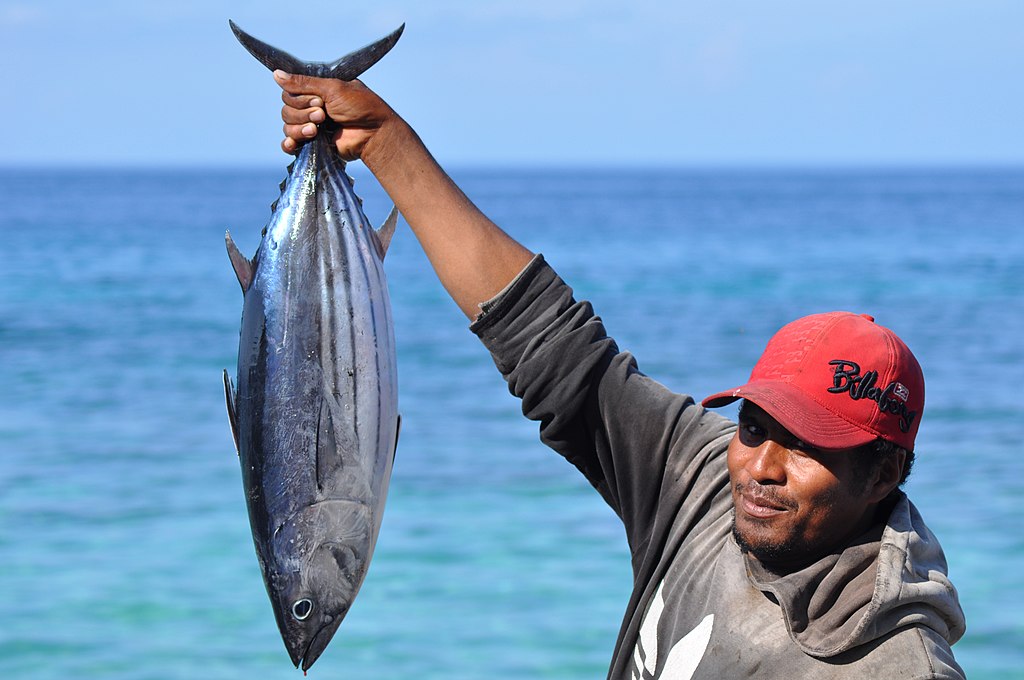 Catch of the day. A small-scale fisherman holds a skipjack tuna that he caught using handline fishing, an environmentally-friendly fishing gear in Namsina Village, Buru Regency, Maluku Province.