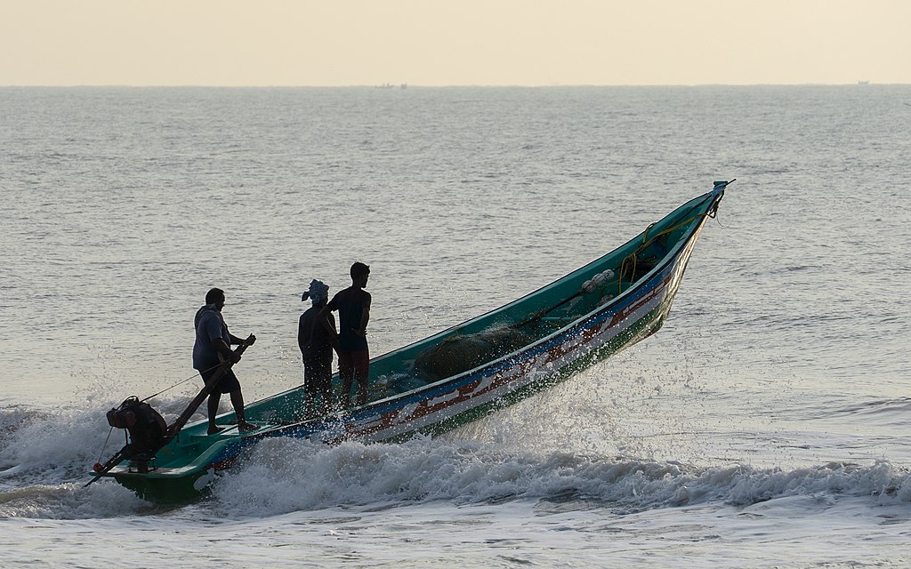 Fishing boat heading out to sea, Devaneri village, Mahabalipuram, Tamil Nadu, India.