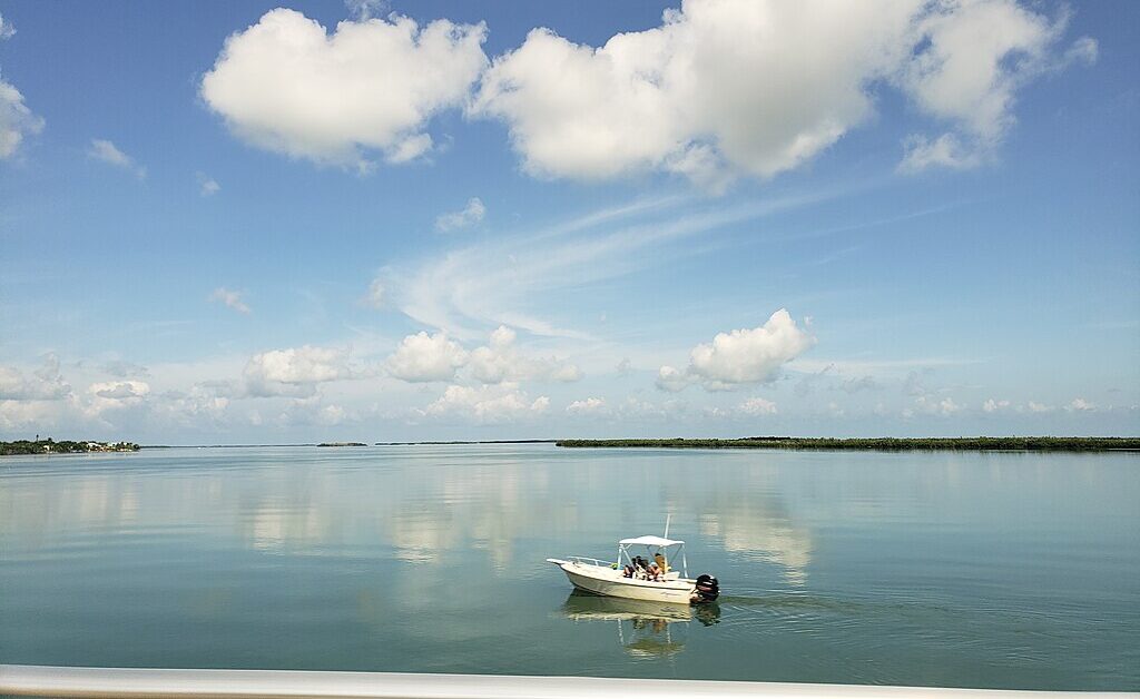A boat cruising through the Bow Channel, between Upper Sugar Loaf Key and Cudjoe Key, FL.