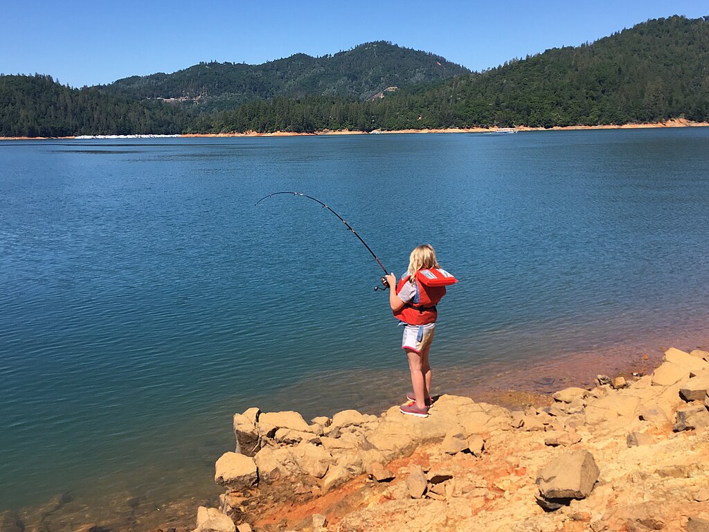 A kid fishing at Shasta Lake.