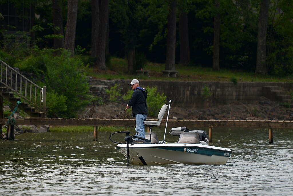 The background features a calm body of water, highlighting the importance of risk management, proper licensing, and planning ahead to prevent accidents during outdoor activities.