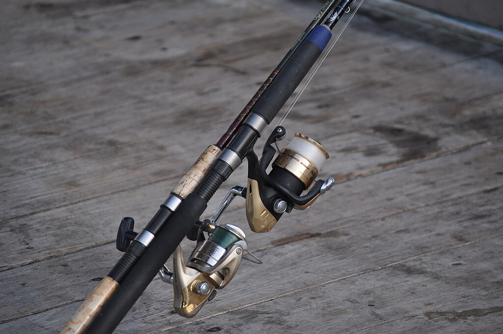 Two spinning fishing reels on the Deerfield Beach, Florida fishing pier.