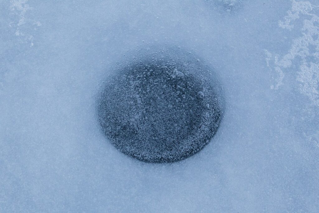 Hole in the ice for ice fishing.