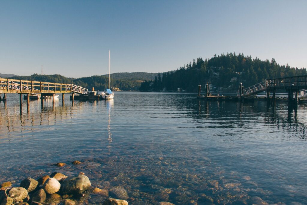 Body of water with wooden docks during daytime.