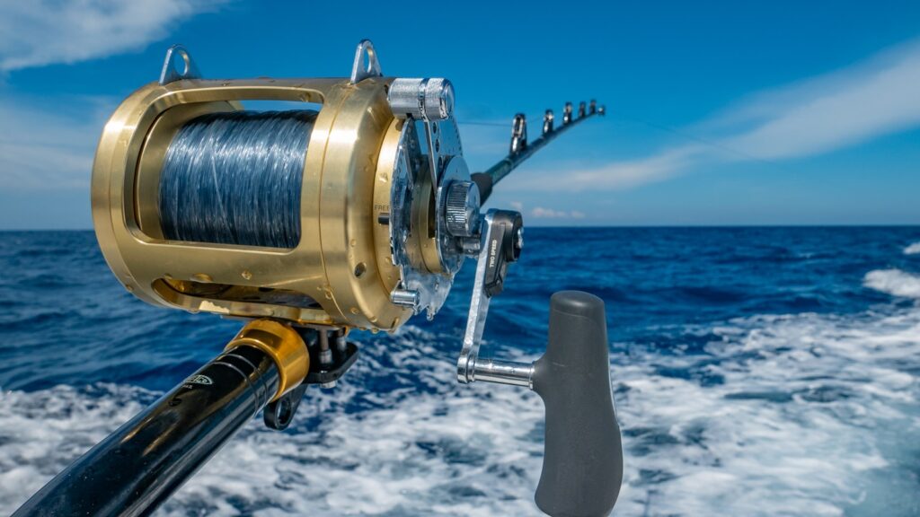 Fishing reel by water during daytime.