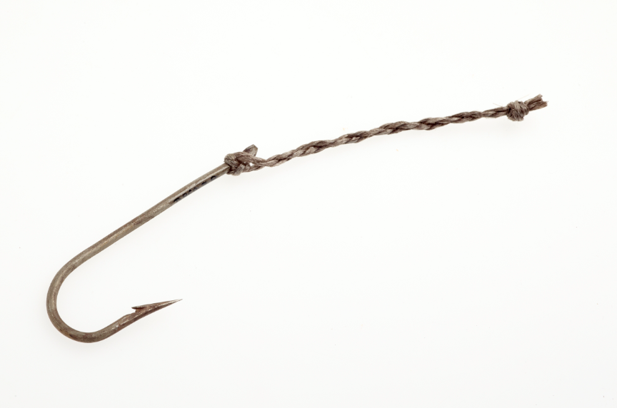 Close-up of a single, large rusty fishing hook with a twisted rope tied to its eye, set against a plain white background. The mood is simple and utilitarian.