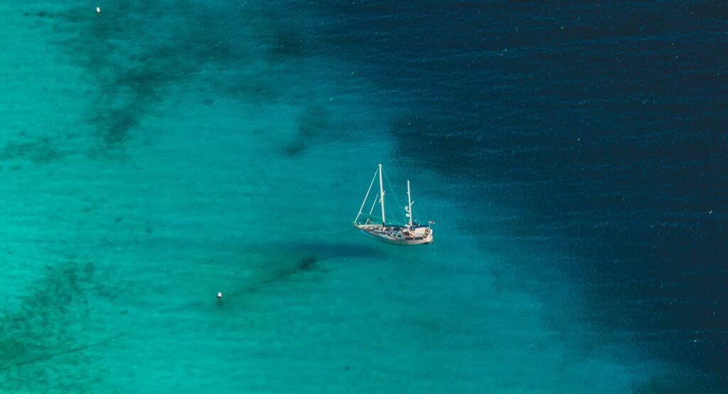 White sailboat on blue sea during daytime.