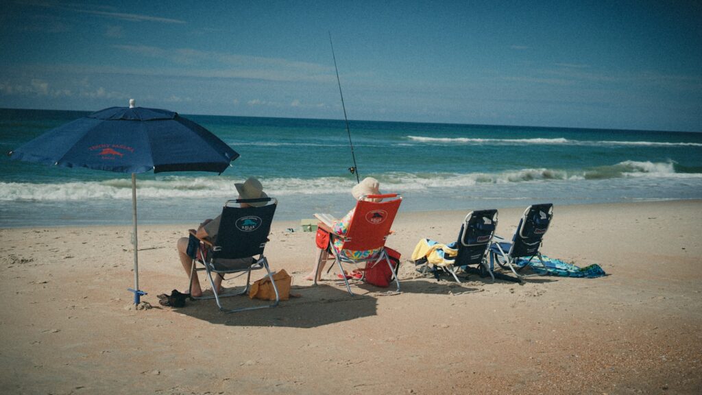 A group of chairs and umbrellas on a beach.