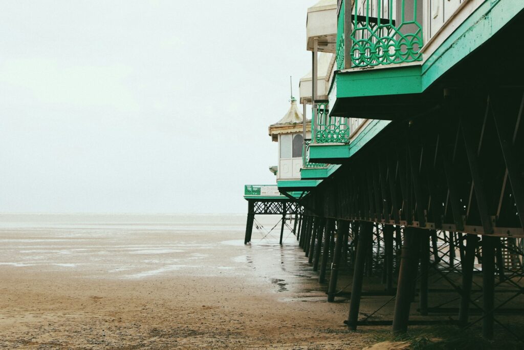Architectural photography of a green and white building on a pier.