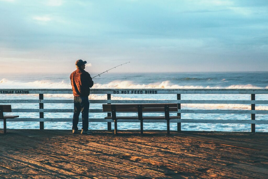 Man fishing by the pier.
