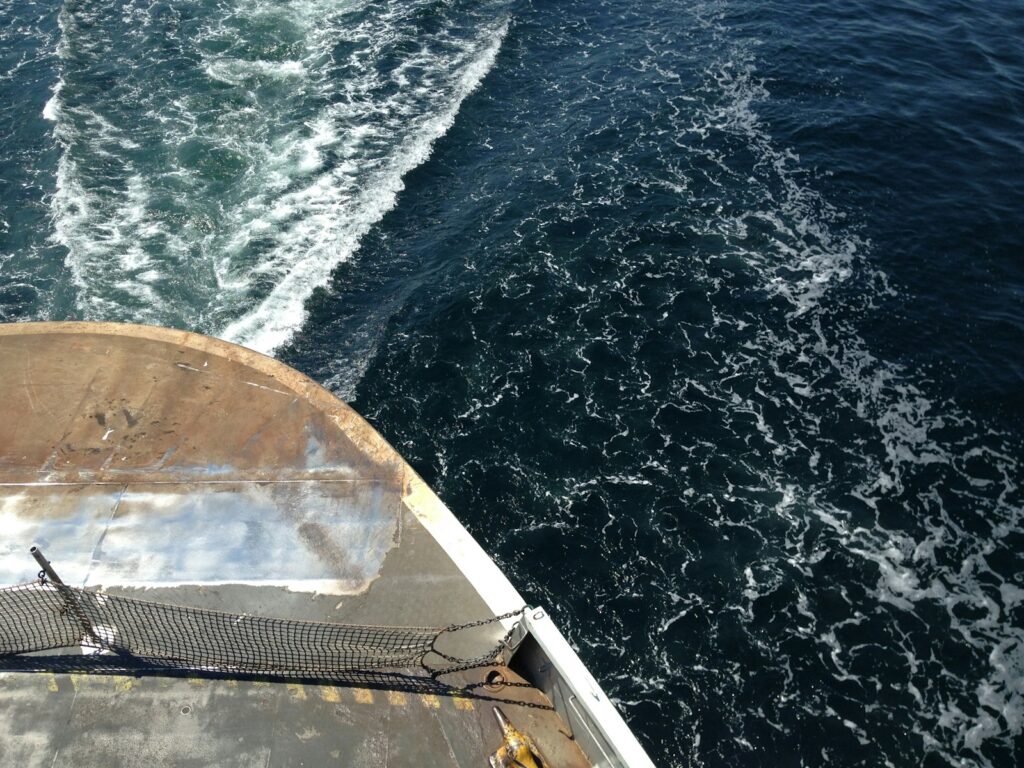 A boat traveling across a body of water.
