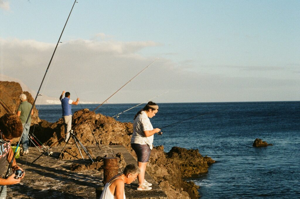 People fishing in the rocks.
