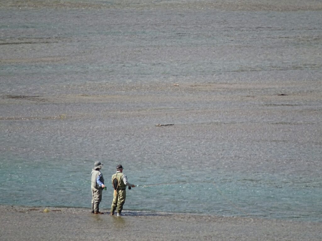 Two men fishing at sea.