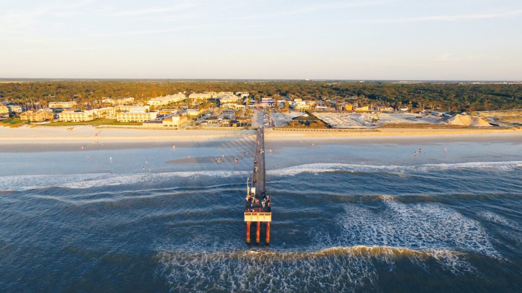 Pier standing on blue waters.