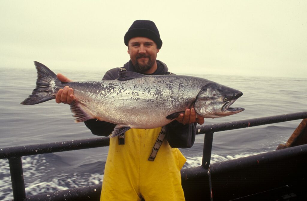 Man carrying silver fish.