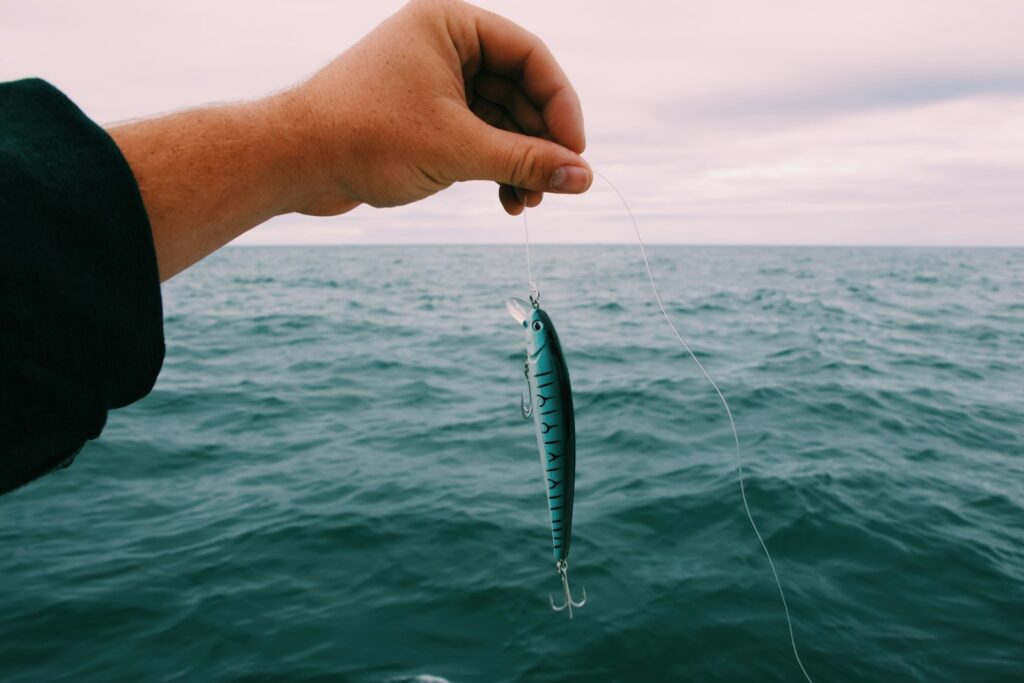 A person holding a fishing bait.