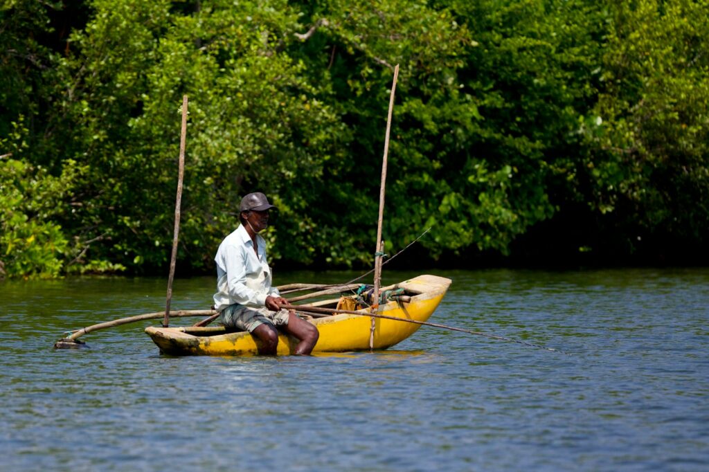 A man sitting in a yellow boat on a river