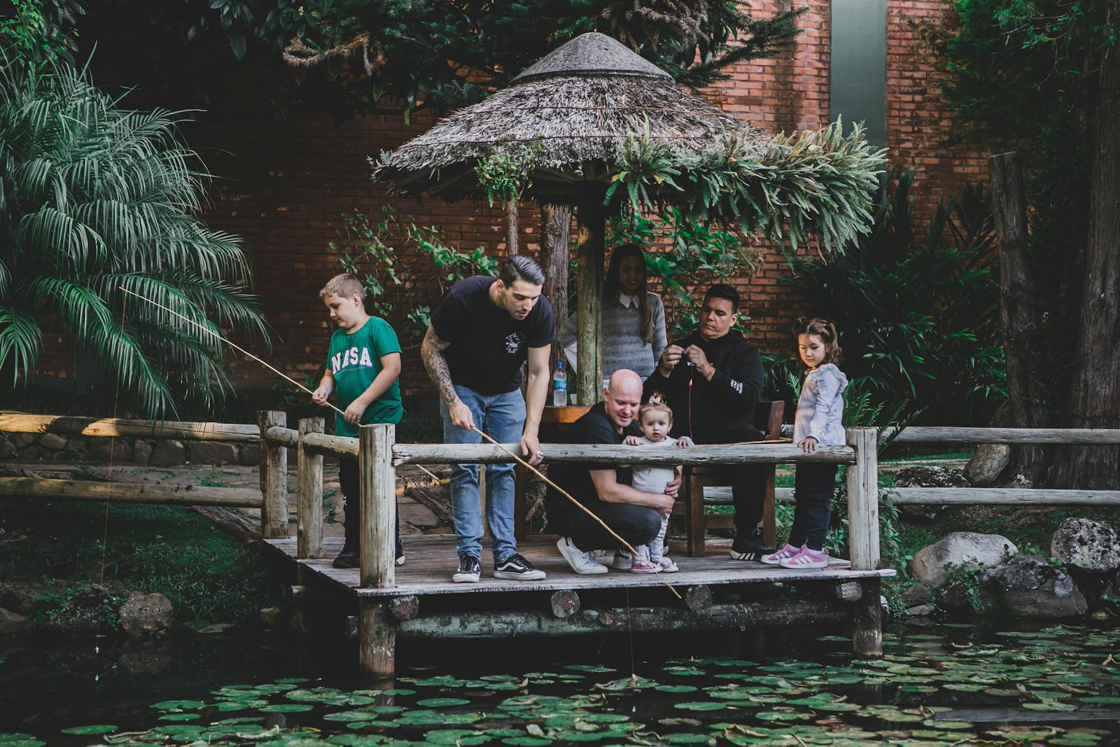 A family enjoys a day fishing and relaxing by a lake in Gramado, Brazil.