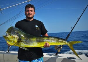 Fernando with his catch: a large male dorado fish caught in the Pacific Ocean.