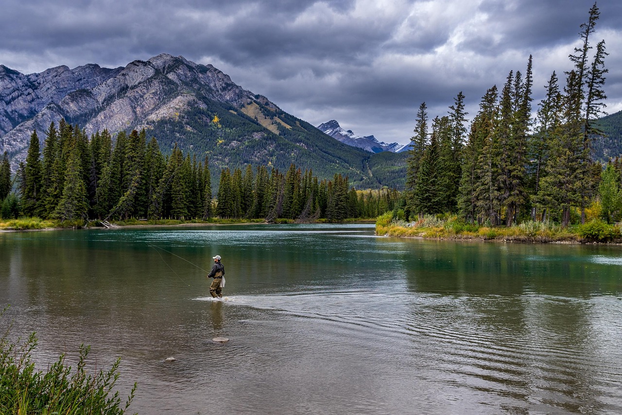Man wading in the river to fish.