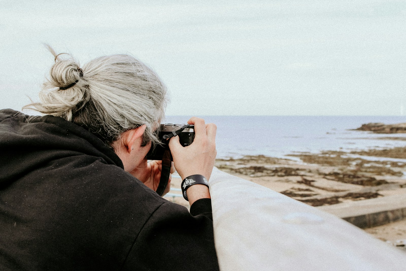 person taking photo of ocean using camera
